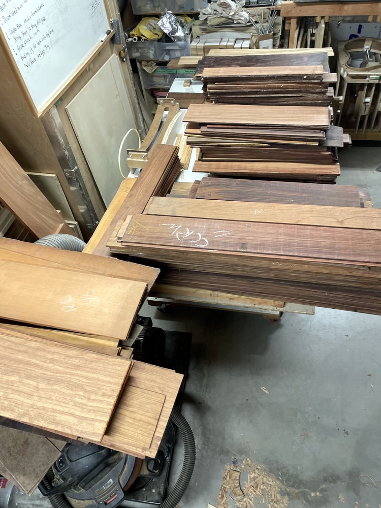 Stacks of raw tonewood stock in the shop
